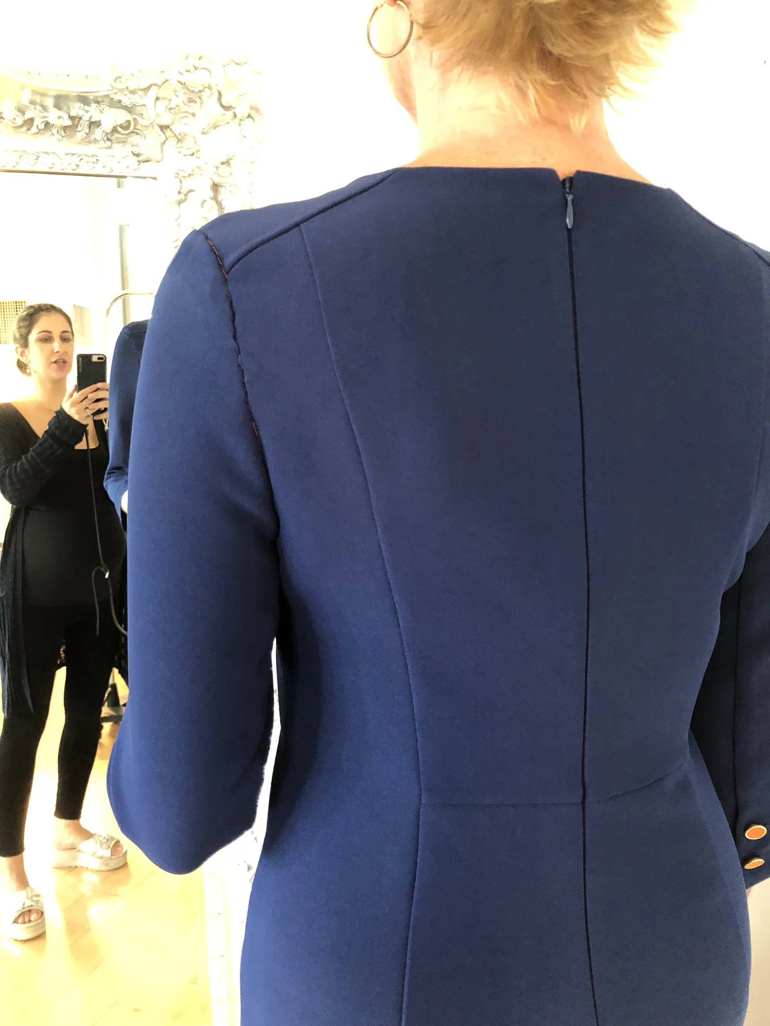 A uniform garment being fitted on a model in the studio